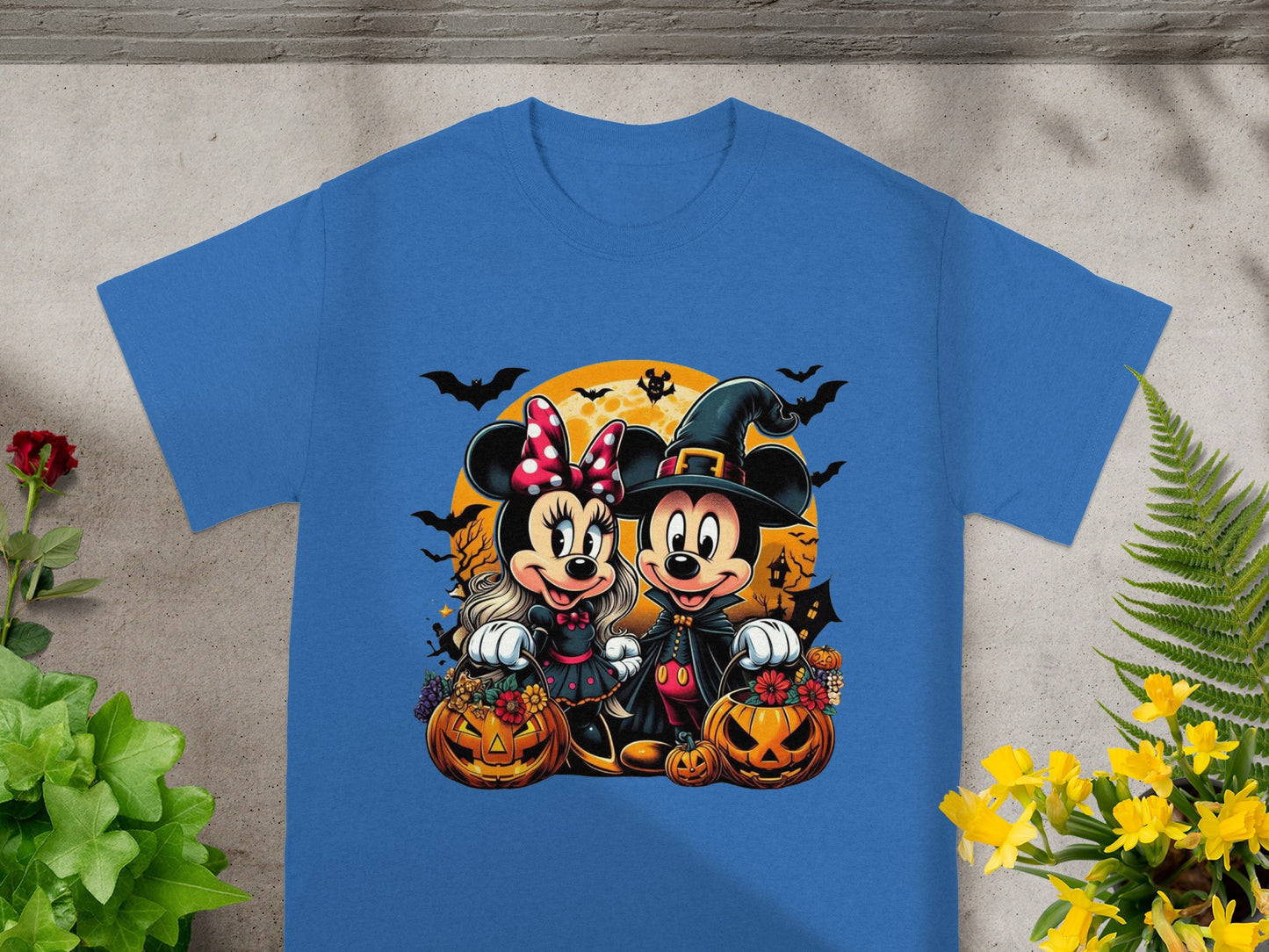 Mickey and Minnie Mouse in Halloween costumes with pumpkins and bats.
