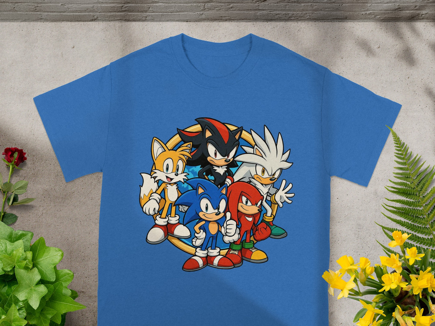 Sonic the Hedgehog, Shadow, Knuckles, and Tails characters on a blue t-shirt.