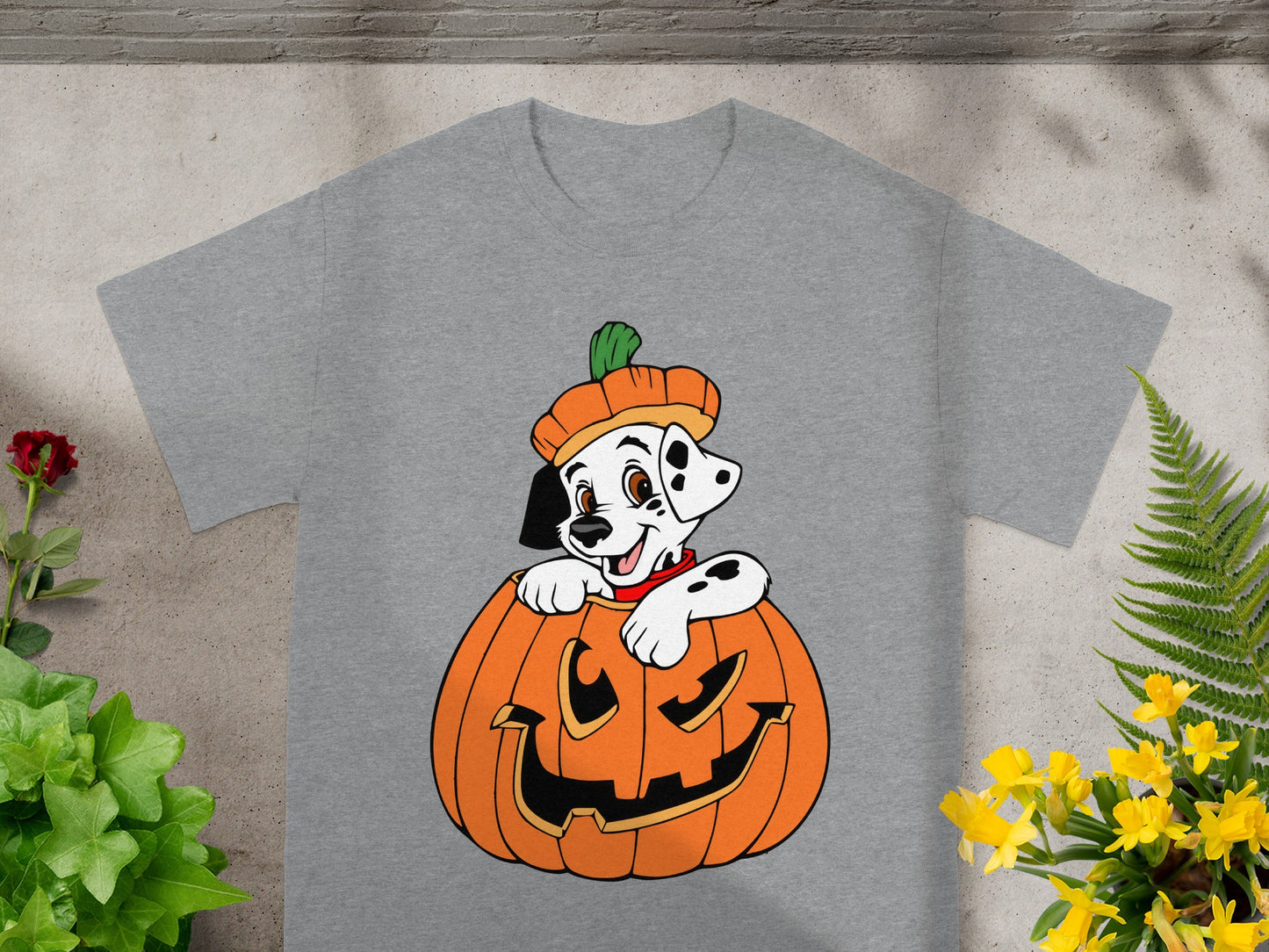 Dalmatian puppy peeking out of a jack-o'-lantern on a grey t-shirt.