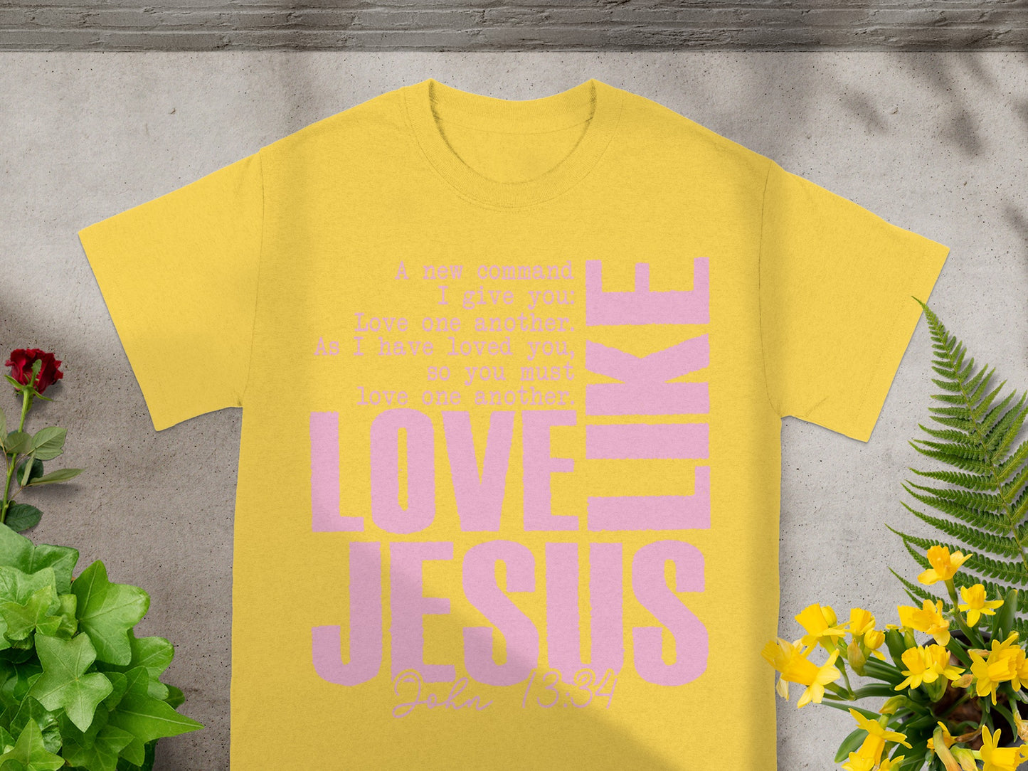 Yellow t-shirt with pink text "LOVE JESUS" and Bible verse John 13:34.
