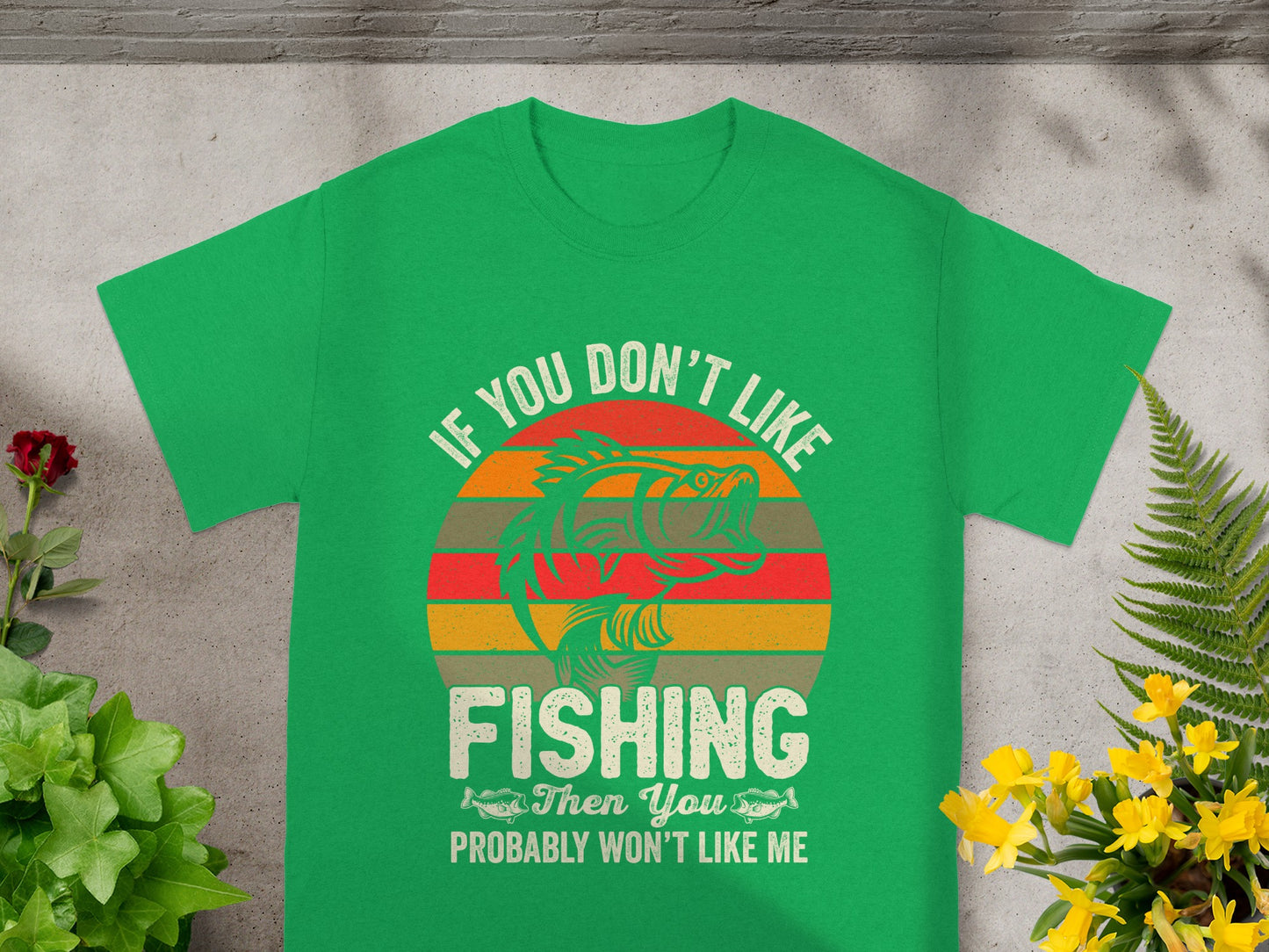 Green t-shirt with text and a fishing graphic.