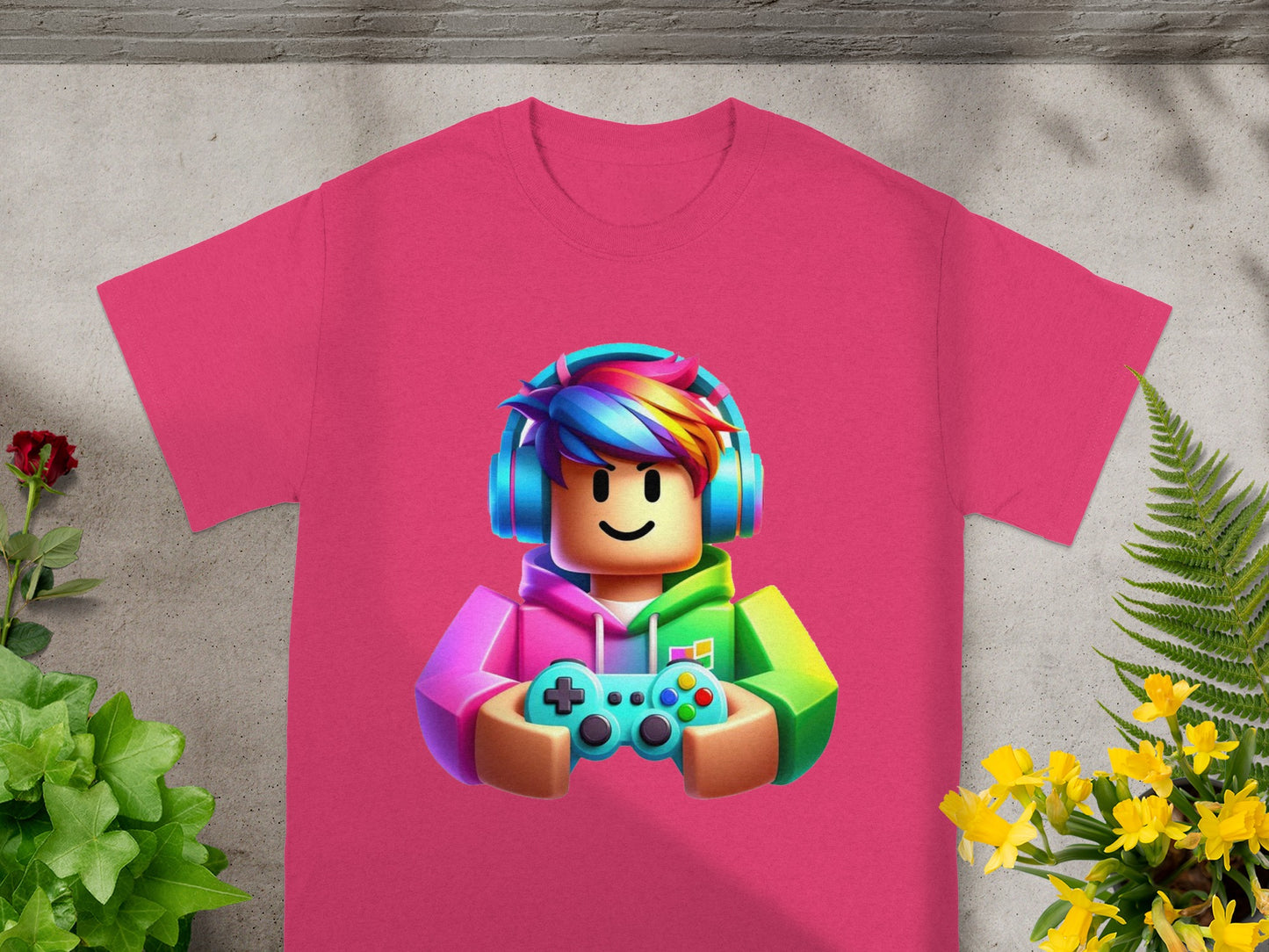 Pink t-shirt with Roblox character wearing headphones and holding a game controller.