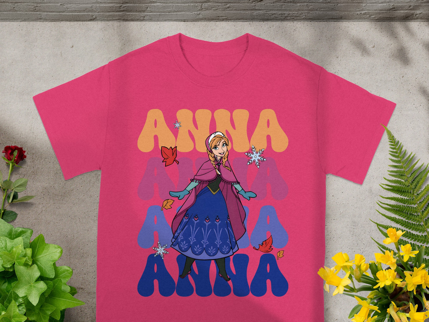 Pink t-shirt with Anna from Frozen graphic and layered "ANNA" text.