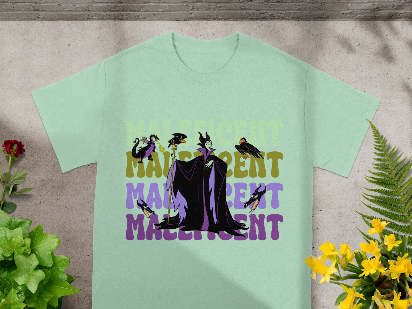 Mint t-shirt with Maleficent graphic and title in a distressed font.