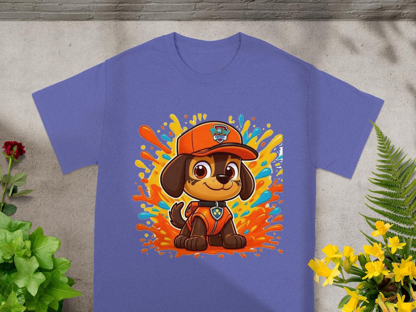 Purple t-shirt featuring a cartoon puppy wearing an orange hat and vest.