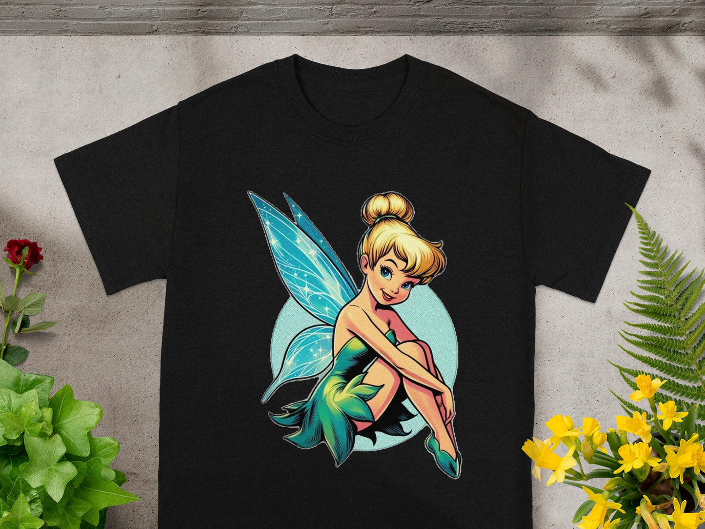 Black t-shirt featuring Tinkerbell sitting with blue wings and green dress.