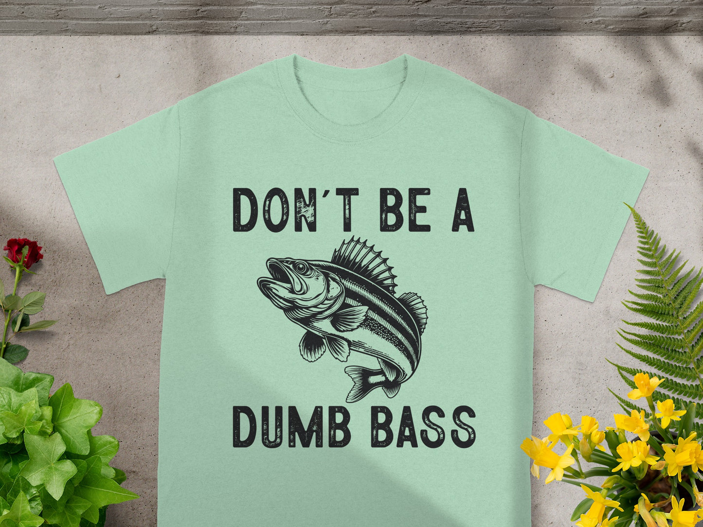 Light green t-shirt with black text and a fish graphic.