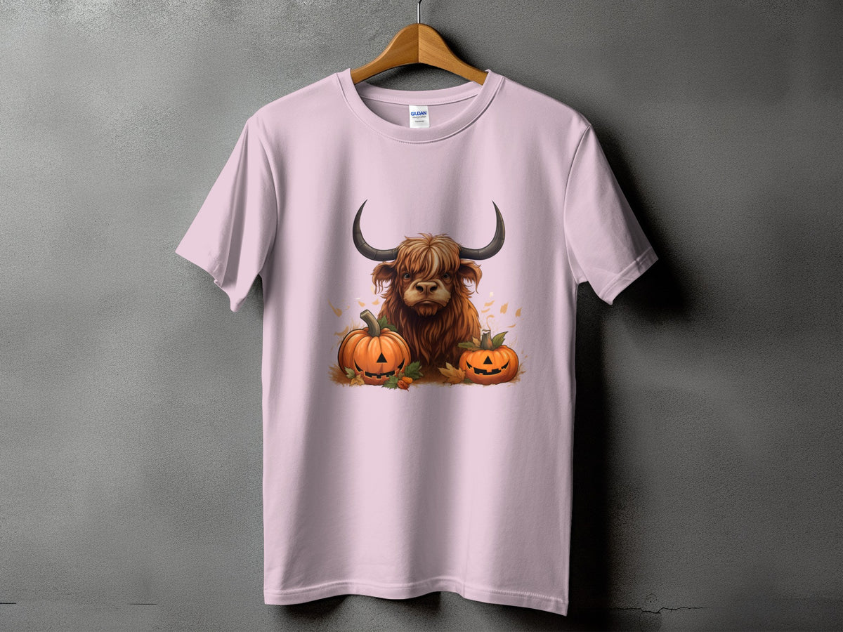 Pink t-shirt with Highland cow and jack-o'-lanterns graphic.