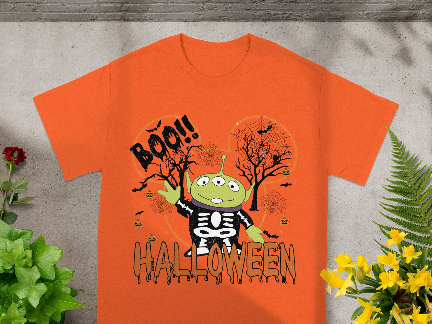 Alien character in skeleton costume with "Boo!!" and "Halloween" text.