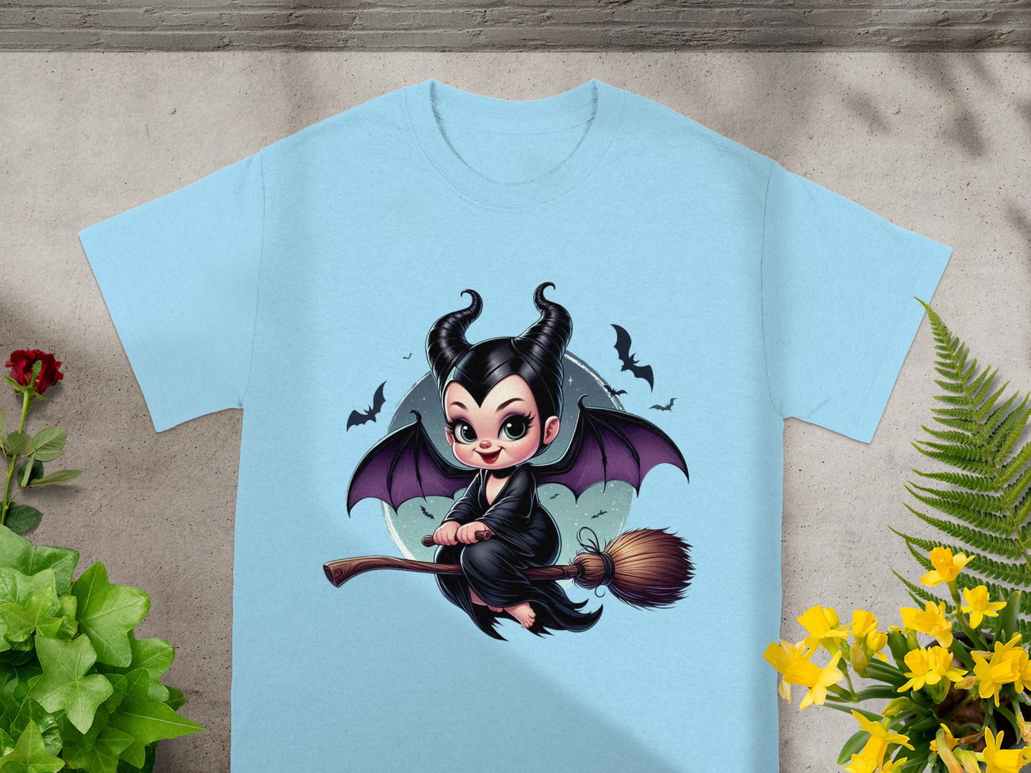 Light blue t-shirt with Maleficent character riding a broomstick.