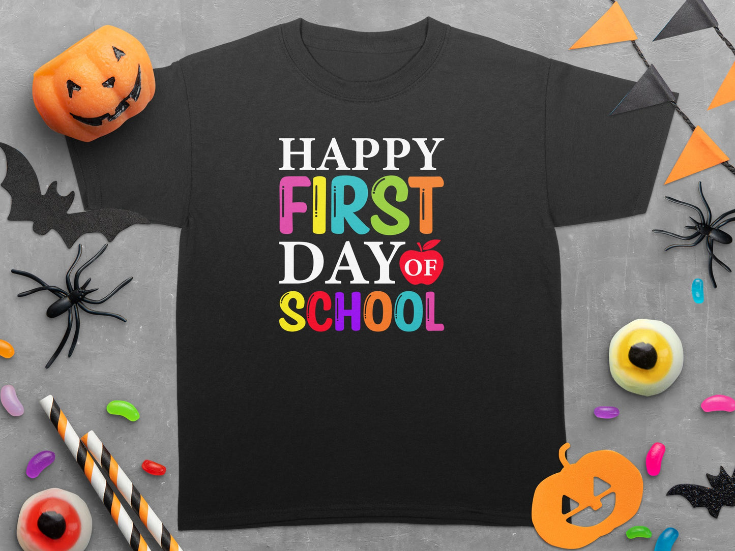 Black t-shirt with "Happy First Day of School" in colorful text.