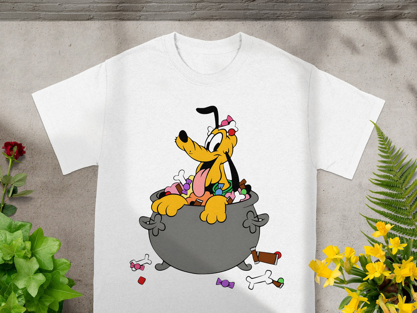 White t-shirt with Pluto sitting in a cauldron full of candy.