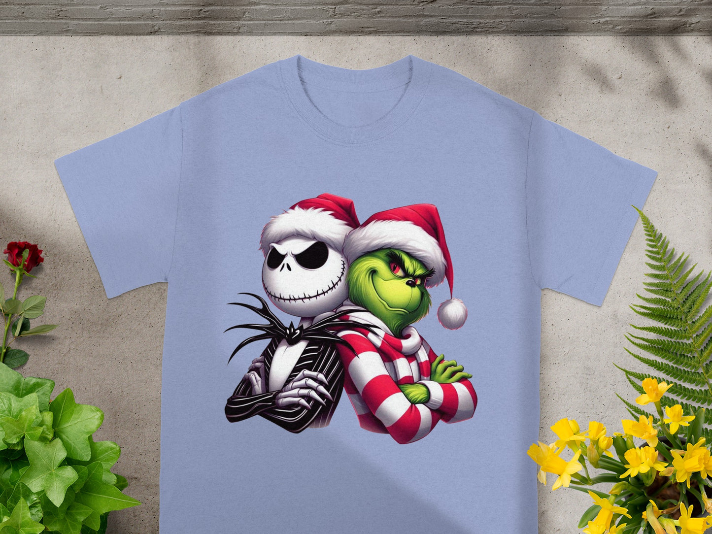 Jack Skellington and The Grinch in Santa hats and winter scarfs on a tee.