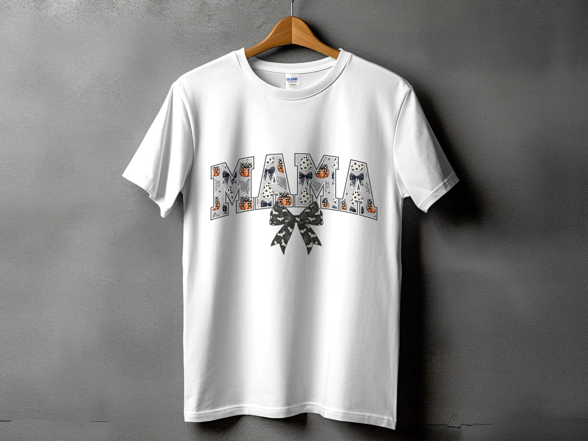 White t-shirt with "MAMA" text in Halloween pattern and a bow.