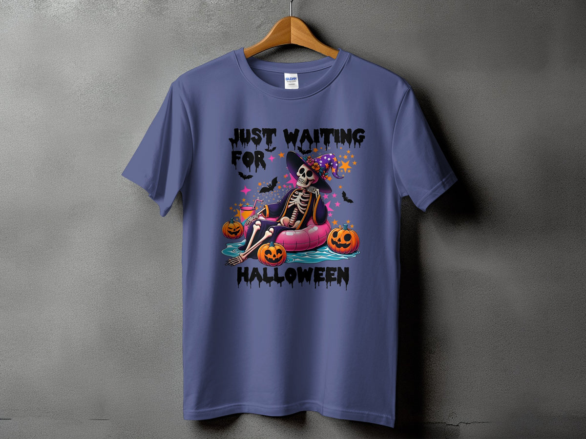 Purple t-shirt with skeleton on inner tube, pumpkins, and text "Just Waiting For Halloween".