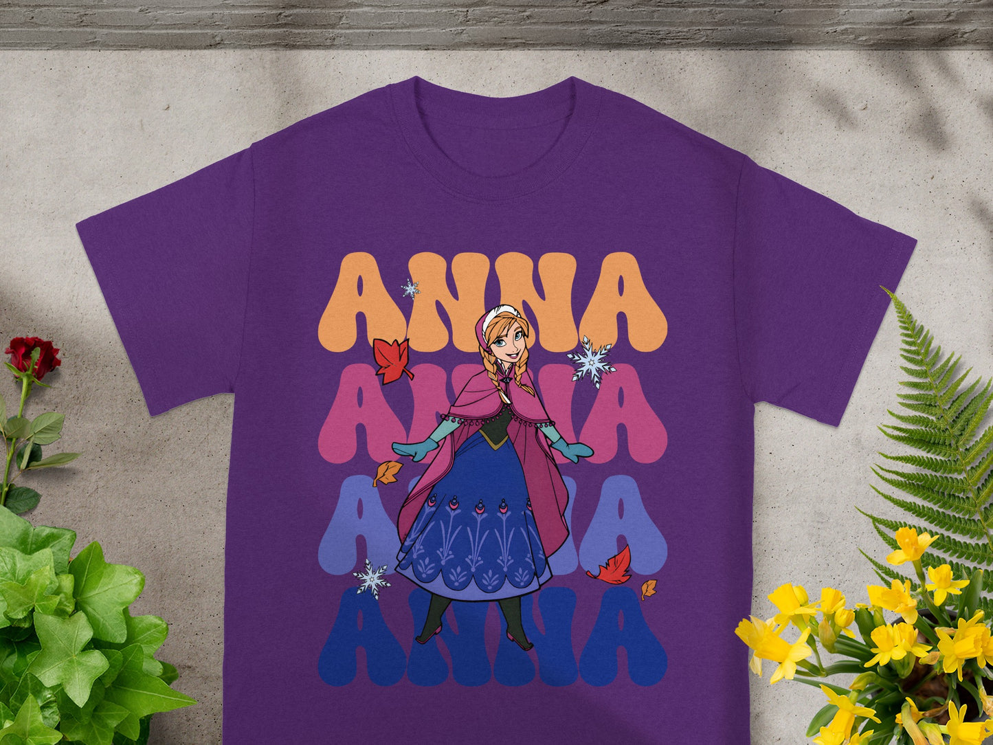 Purple t-shirt with Anna from Frozen and colorful text.