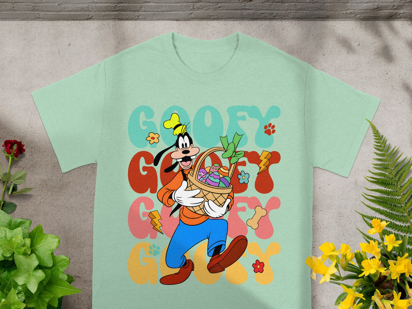 Goofy with Easter basket and text "GOOFY" on a mint green t-shirt.