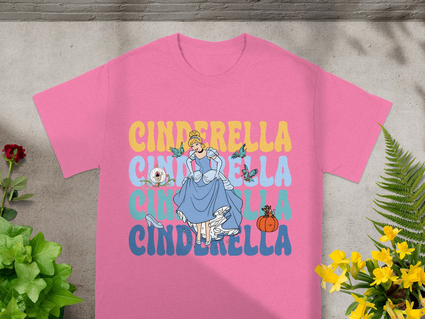 Pink t-shirt with Cinderella in a blue gown and text.