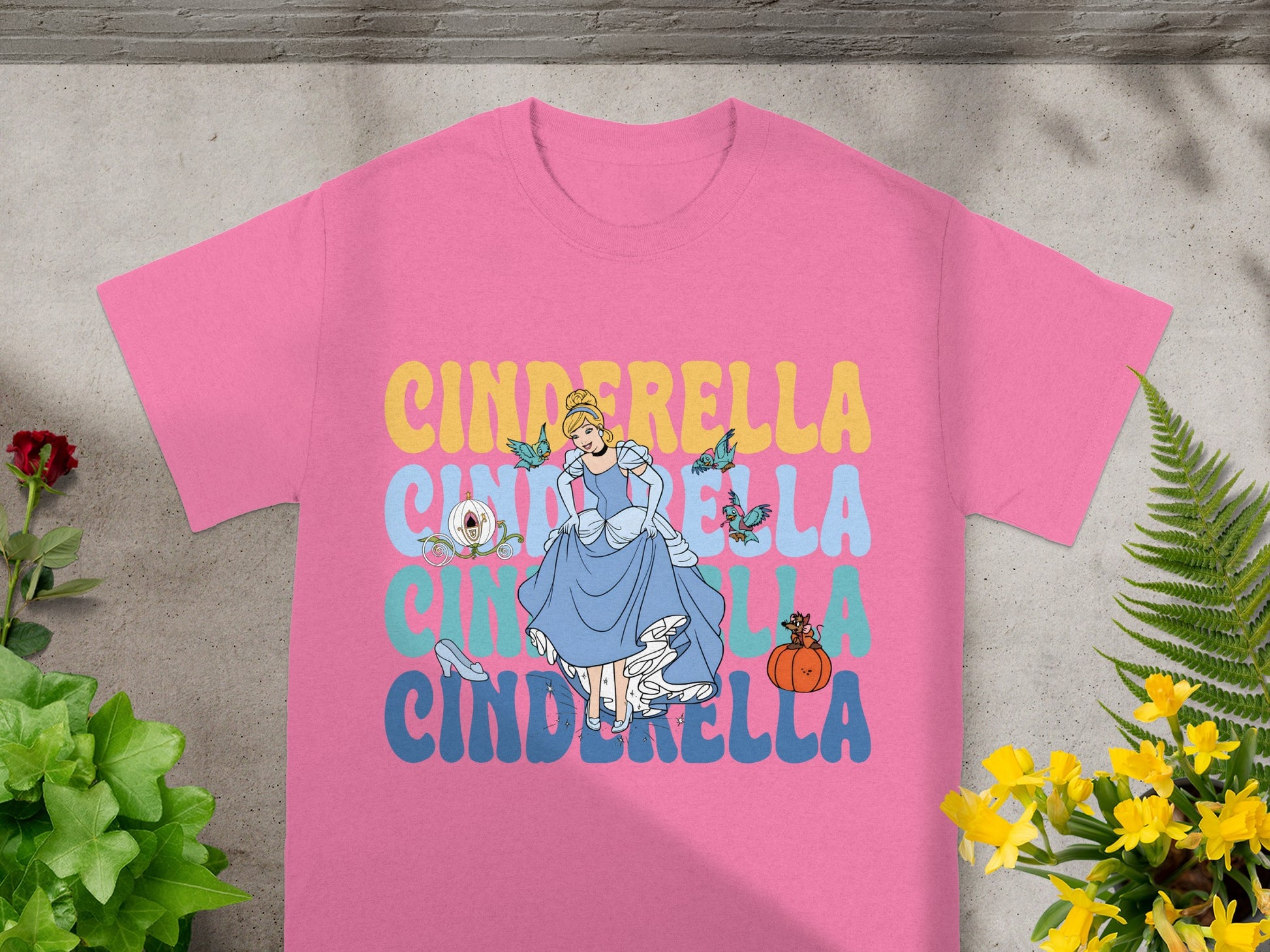 Pink t-shirt with Cinderella in a blue gown and text.