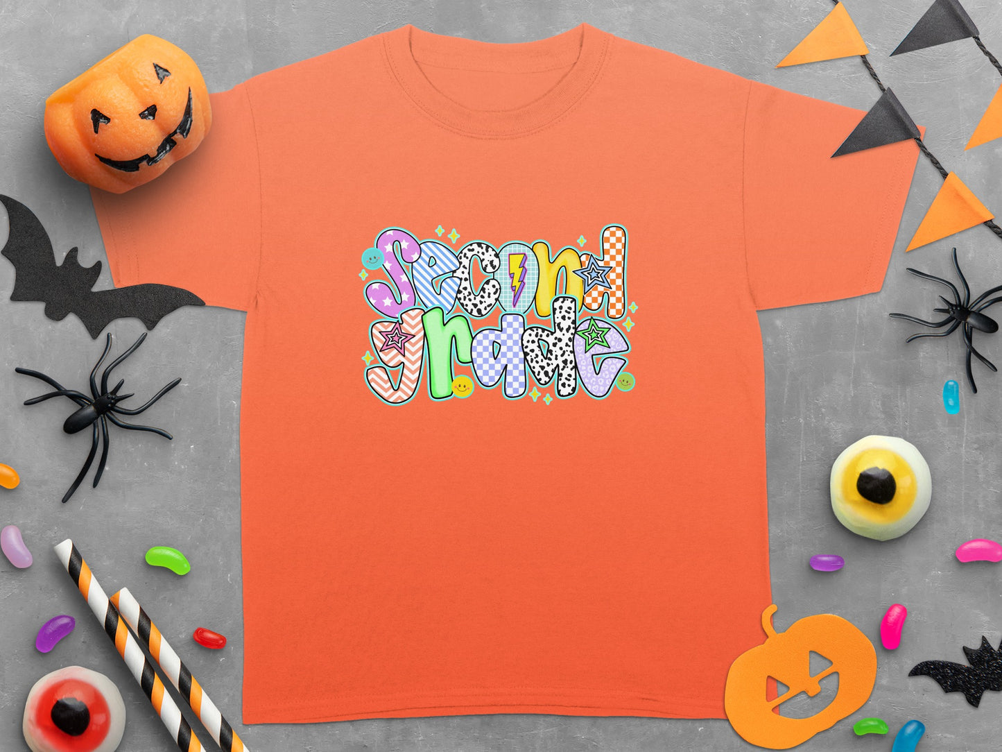 Orange t-shirt with "Second Grade" text in colorful, patterned letters.