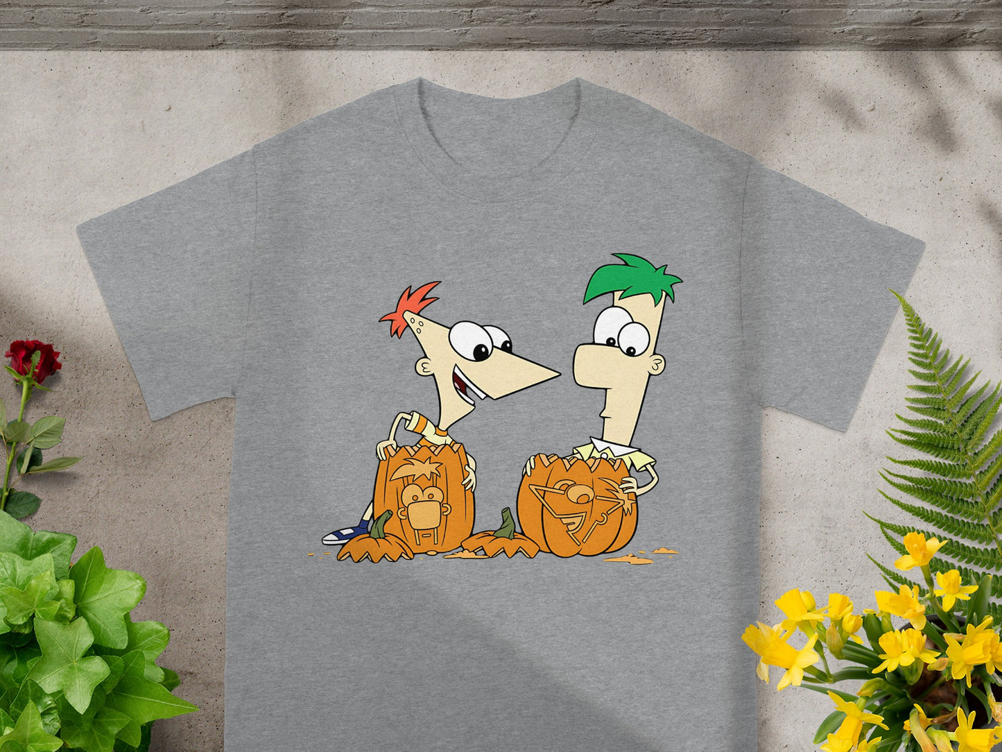 Phineas and Ferb carved pumpkins with their faces on a grey t-shirt.