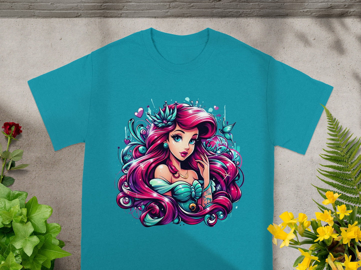 Teal t-shirt with Ariel from The Little Mermaid in vibrant, stylized illustration.