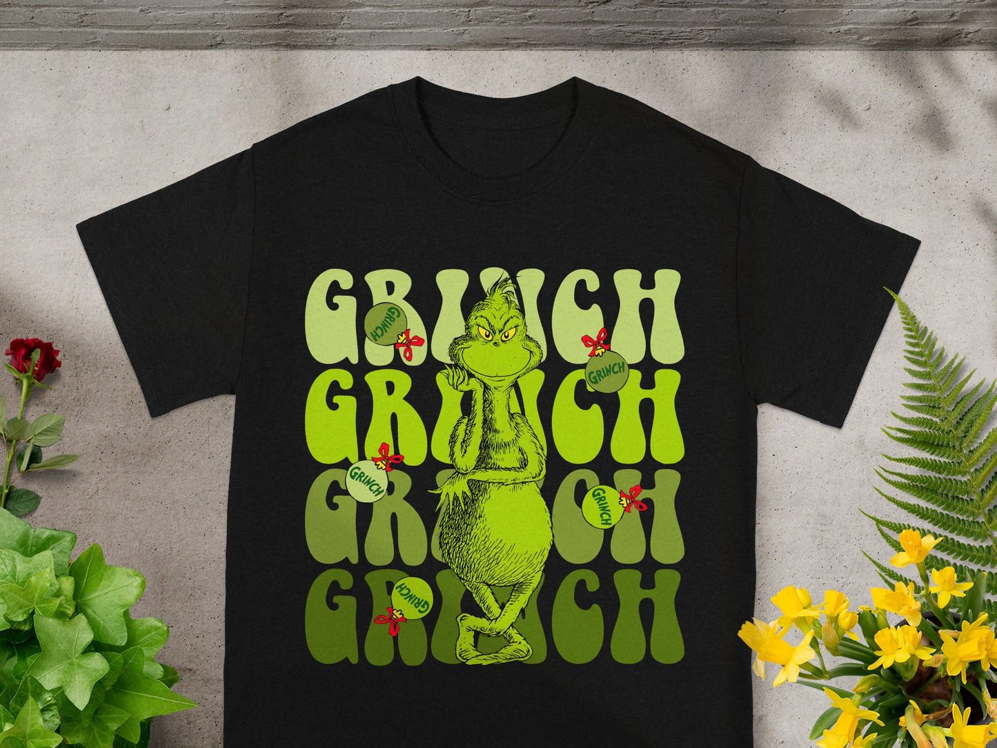 Black t-shirt with "Grinch" text and character graphics.