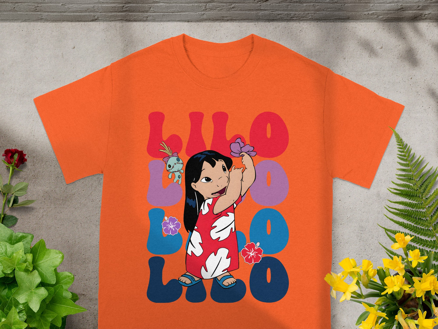 Lilo & Stitch t-shirt with large colorful text and Lilo holding a flower.