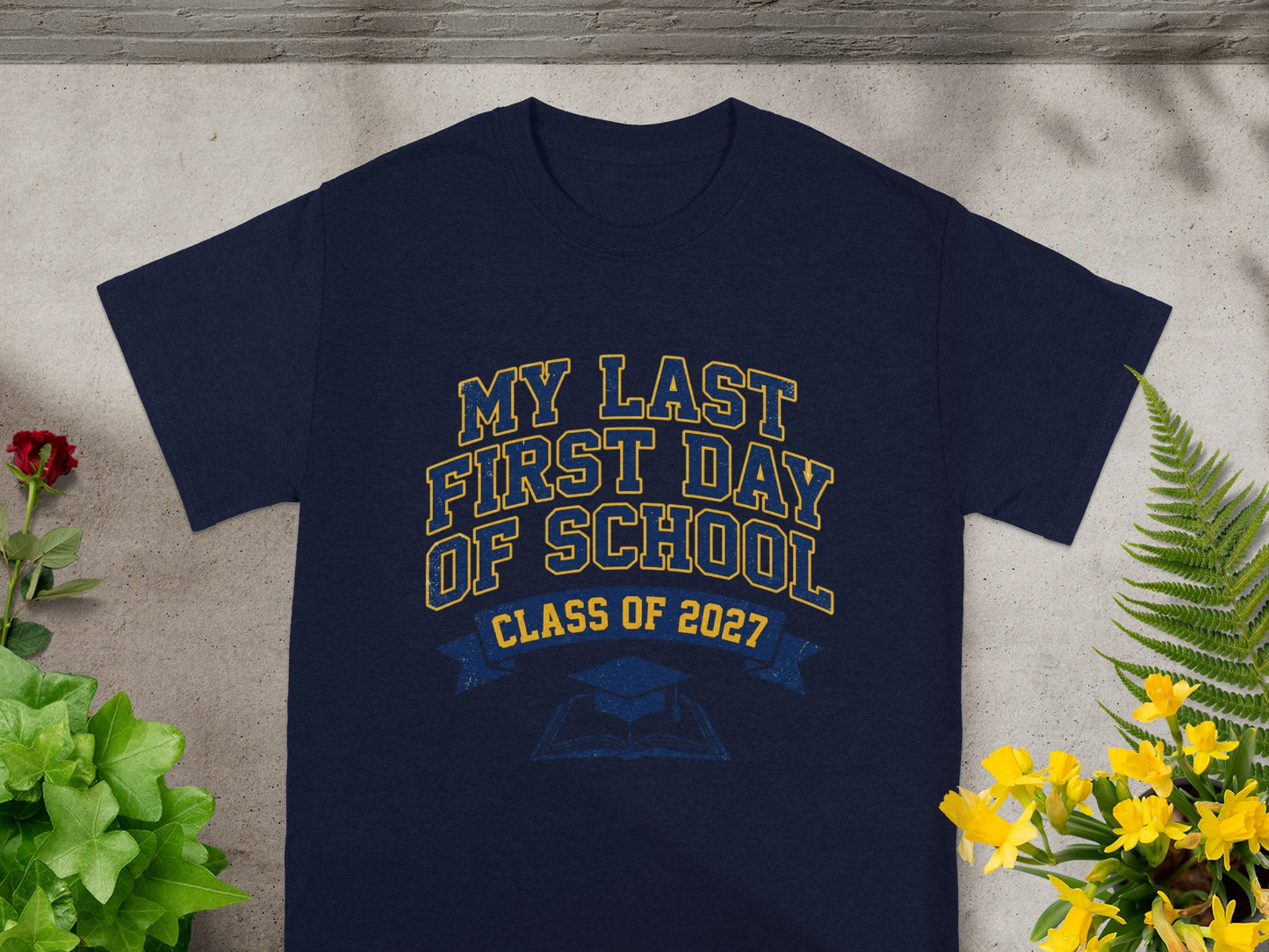 Navy t-shirt with "My Last First Day of School Class of 2027" text and graphics.