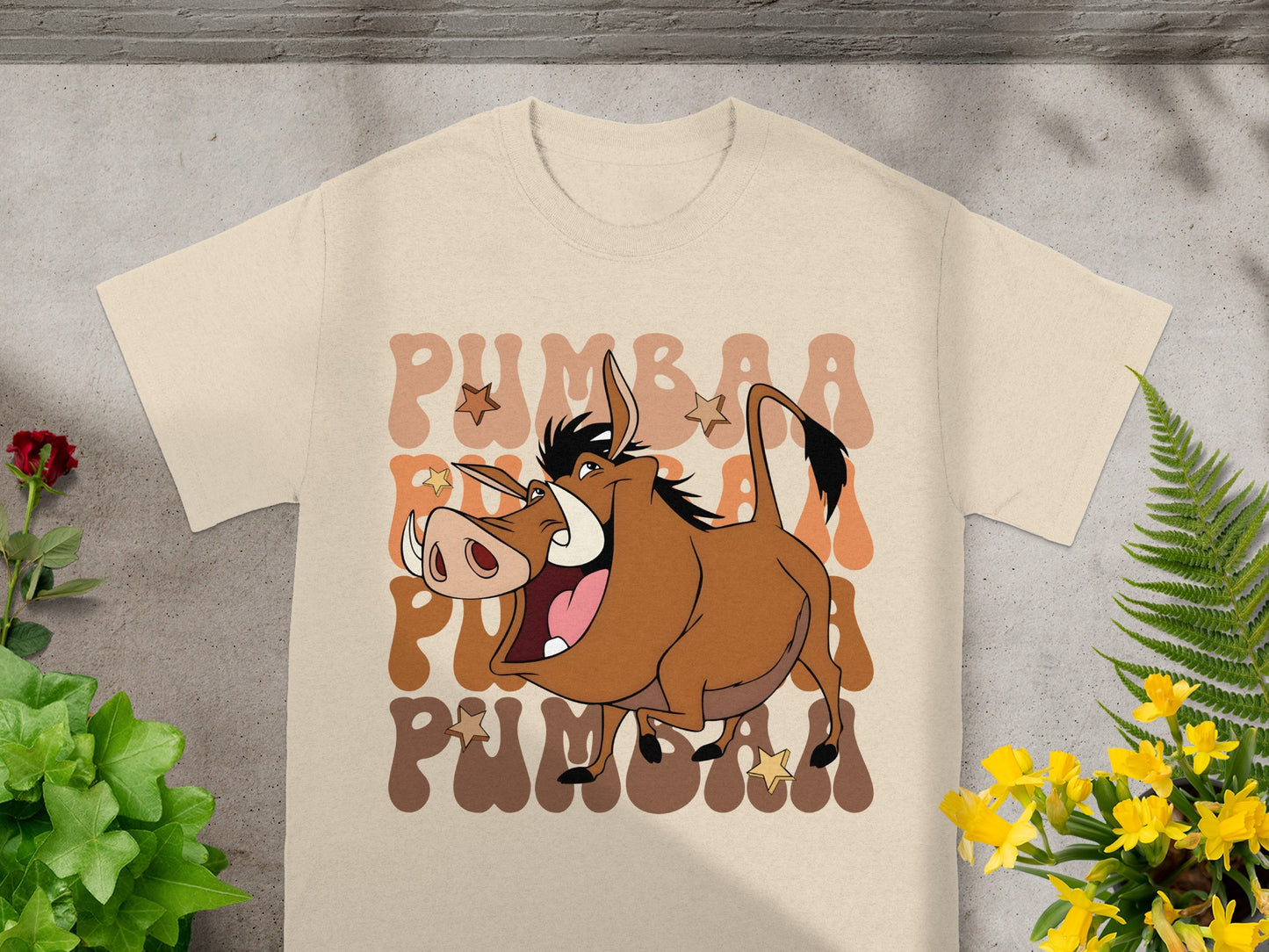 Pumbaa from The Lion King on a tan t-shirt with "Pumbaa" text.