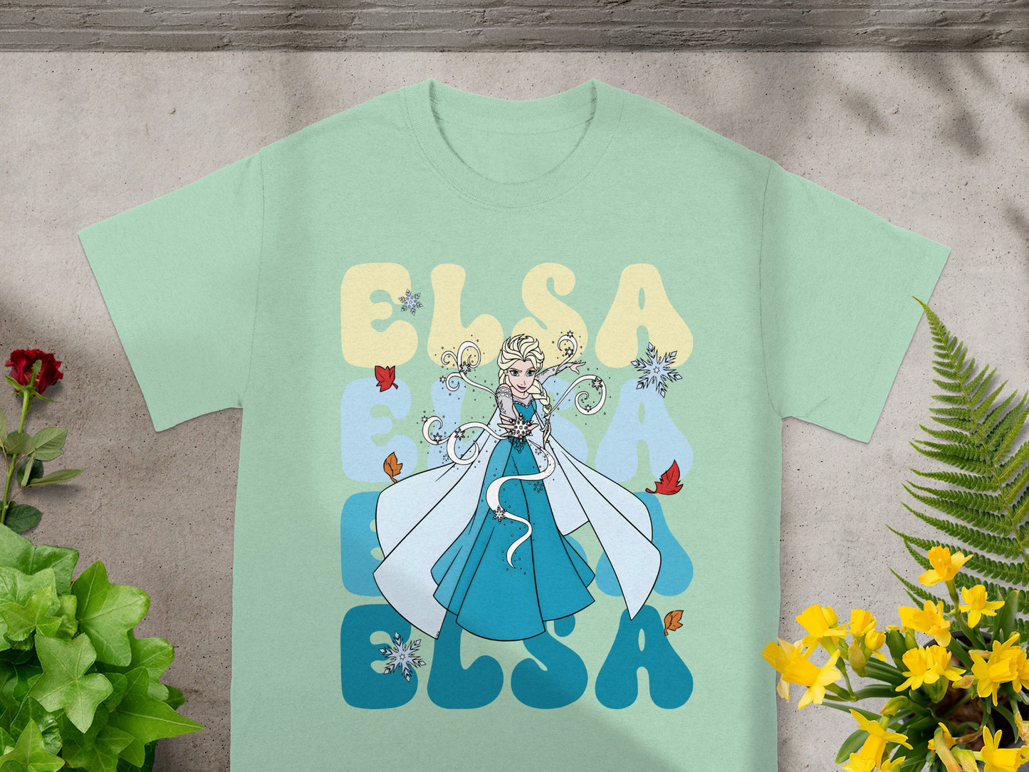Mint t-shirt with Elsa character and "ELSA" text in large blue letters.
