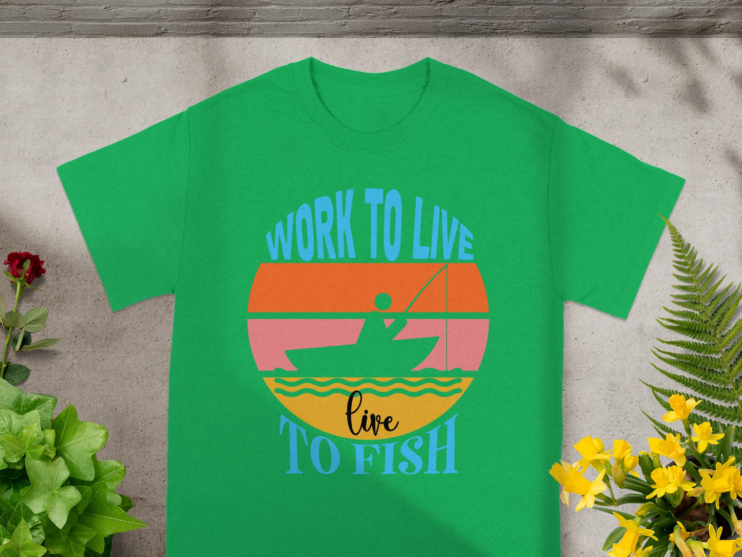 Green t-shirt with "Work to Live Live To Fish" design featuring a sunset and fishing boat.