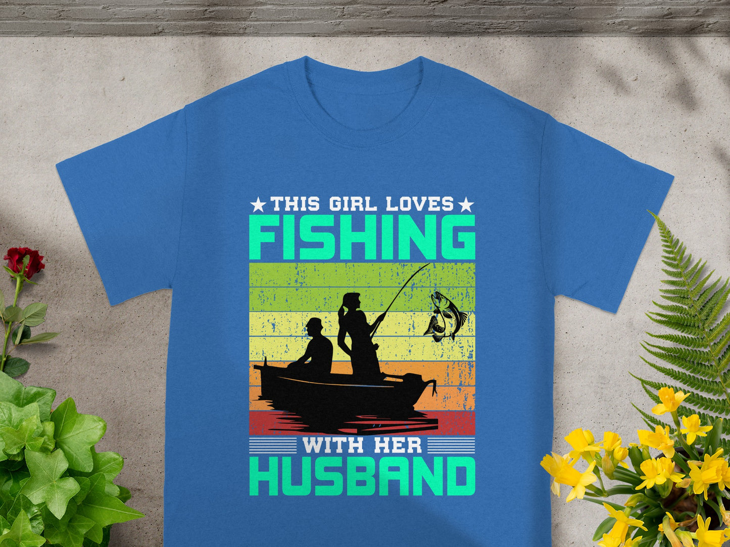 This girl loves fishing with her husband graphic on a blue t-shirt.