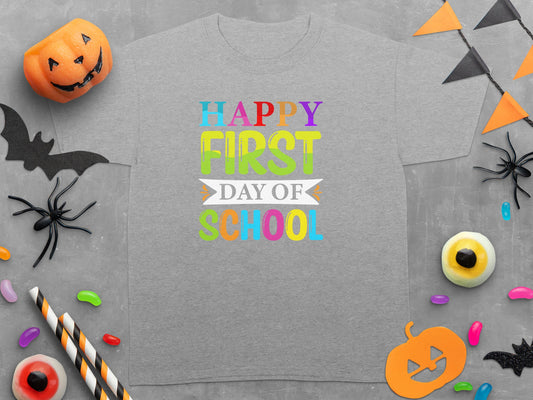 Grey t-shirt with colorful text "Happy First Day of School" and Halloween decorations.