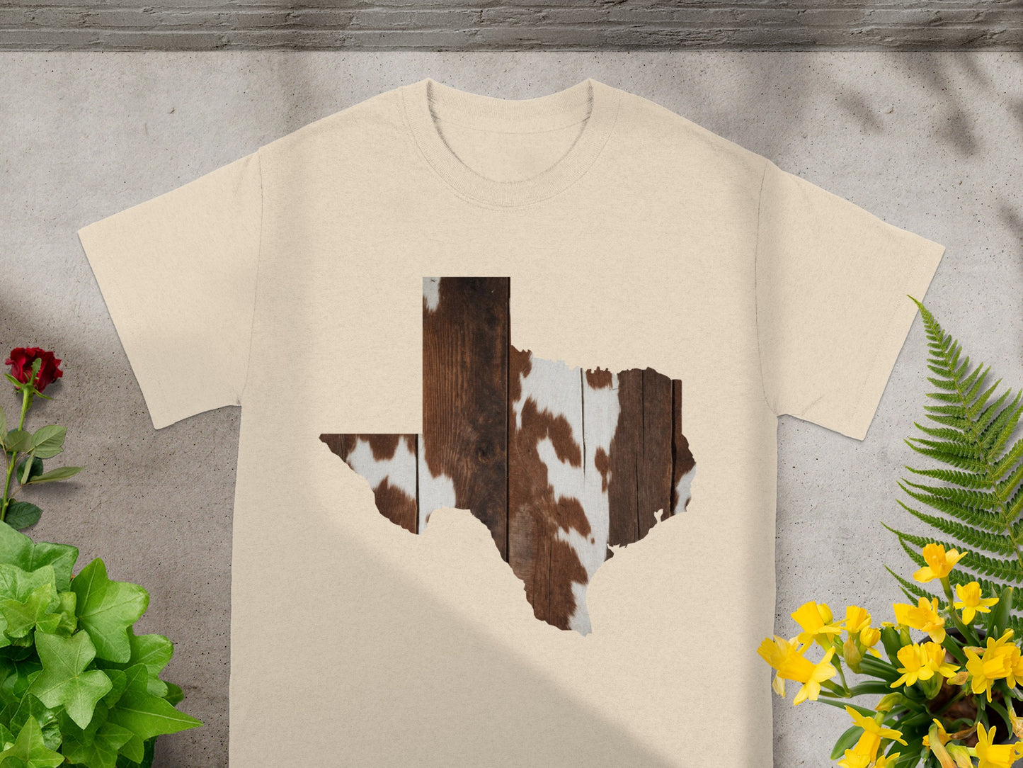 Tan t-shirt with Texas shape filled with wood and cowhide pattern.
