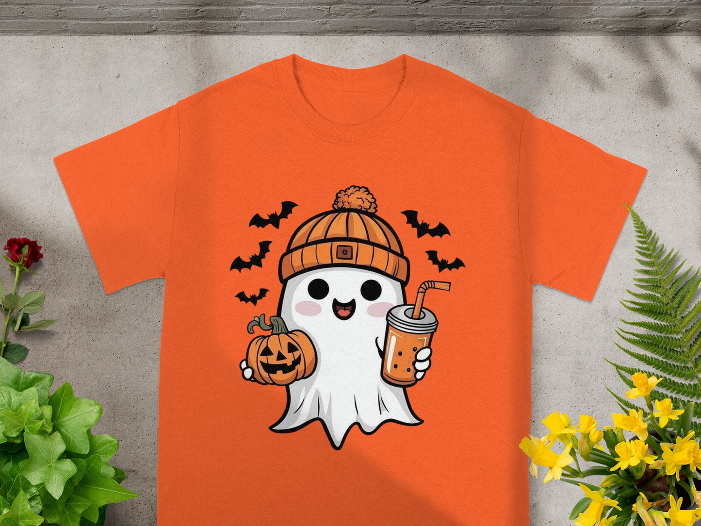 Orange t-shirt with a cartoon ghost holding a pumpkin and bubble tea.
