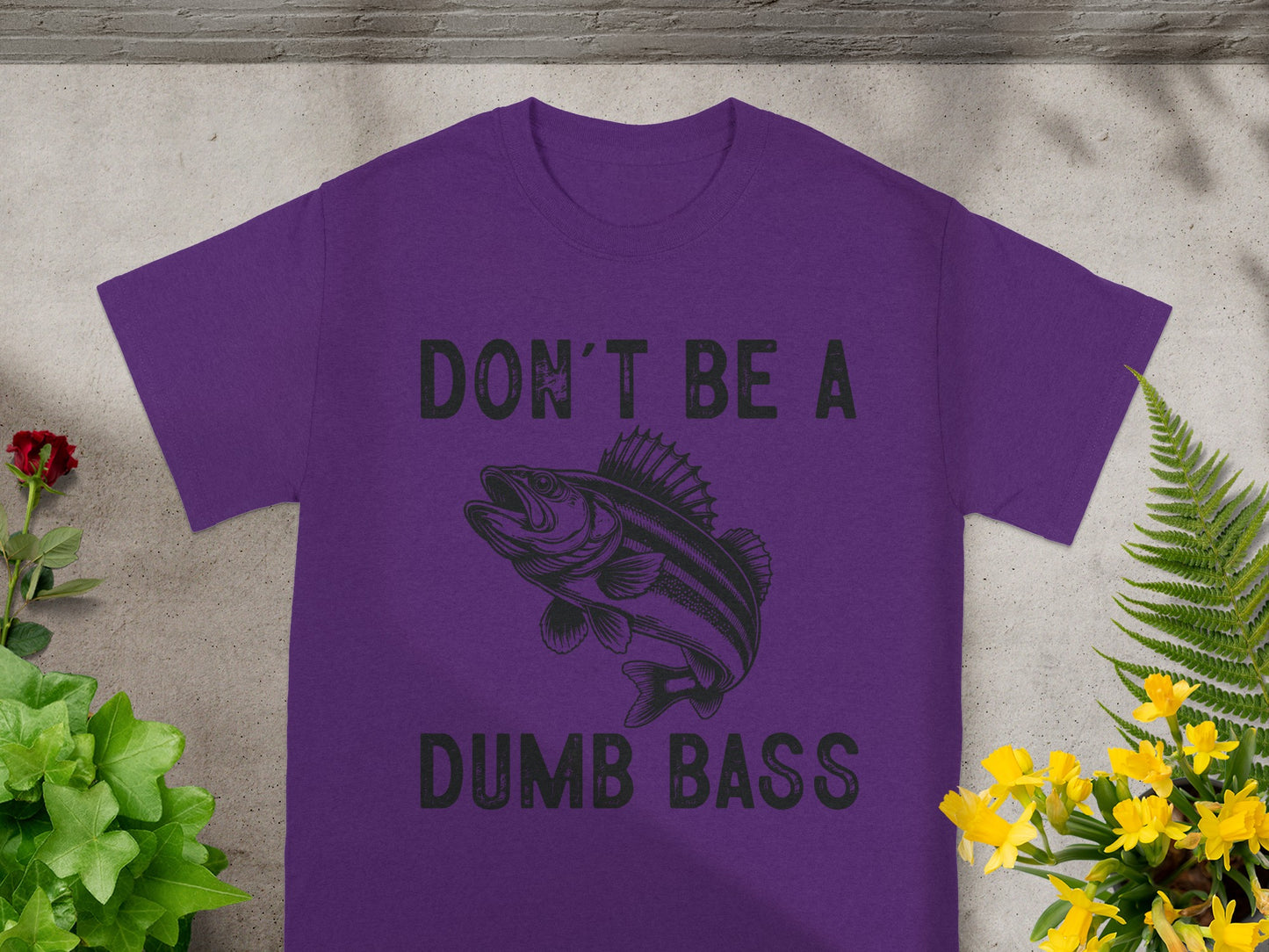 Purple t-shirt with graphic of a fish and text "DON'T BE A DUMB BASS."
