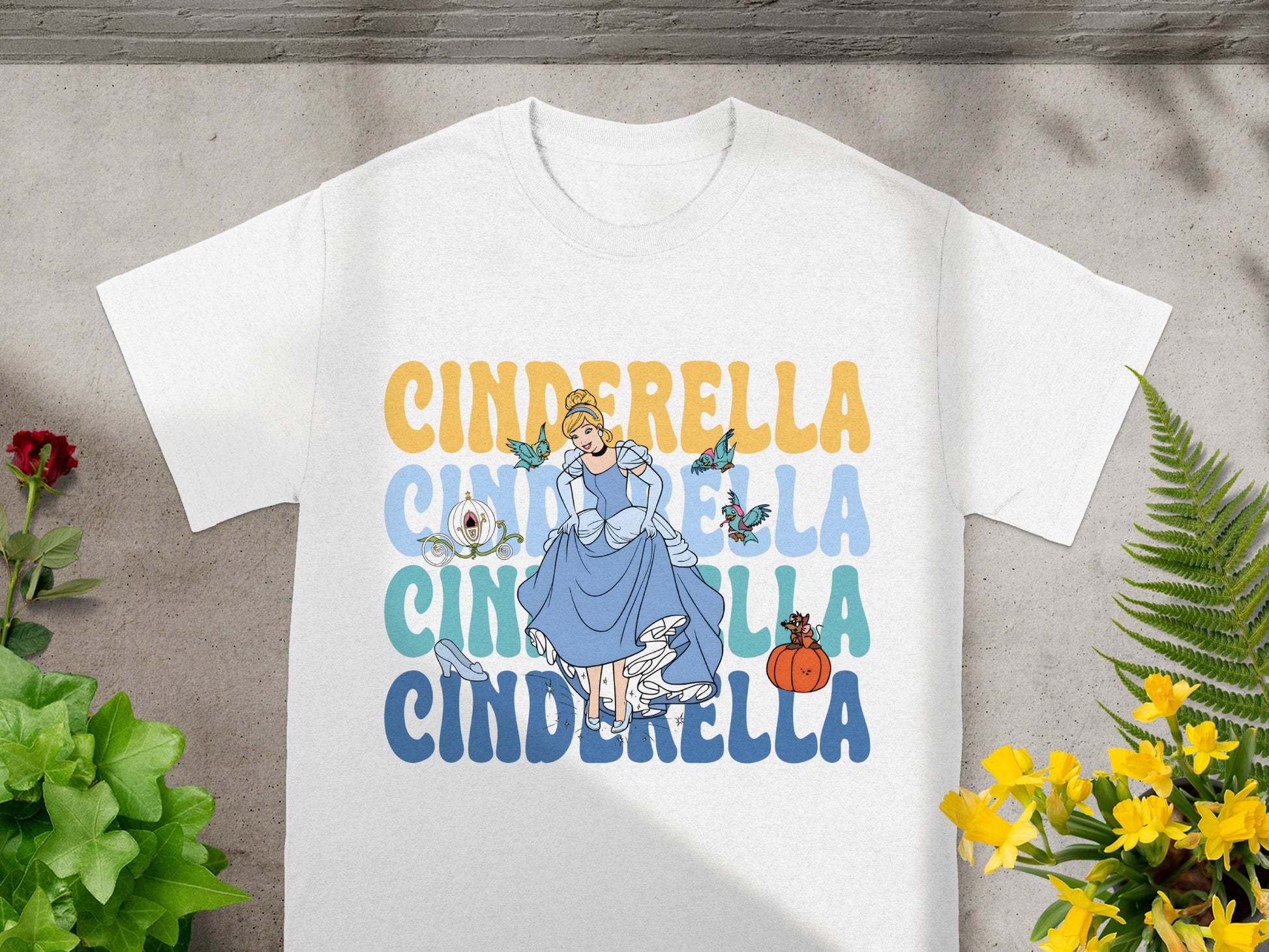 White t-shirt with Cinderella graphic and text.