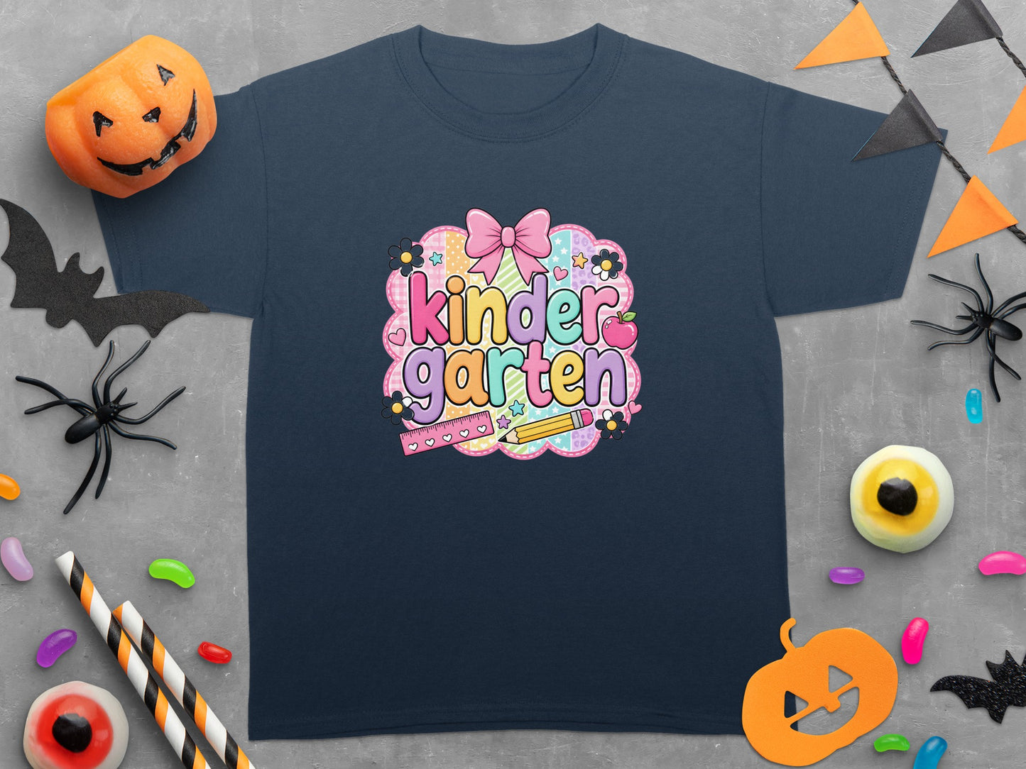 Navy t-shirt with "kinder garten" text, bow, apple, ruler, and pencil graphic.
