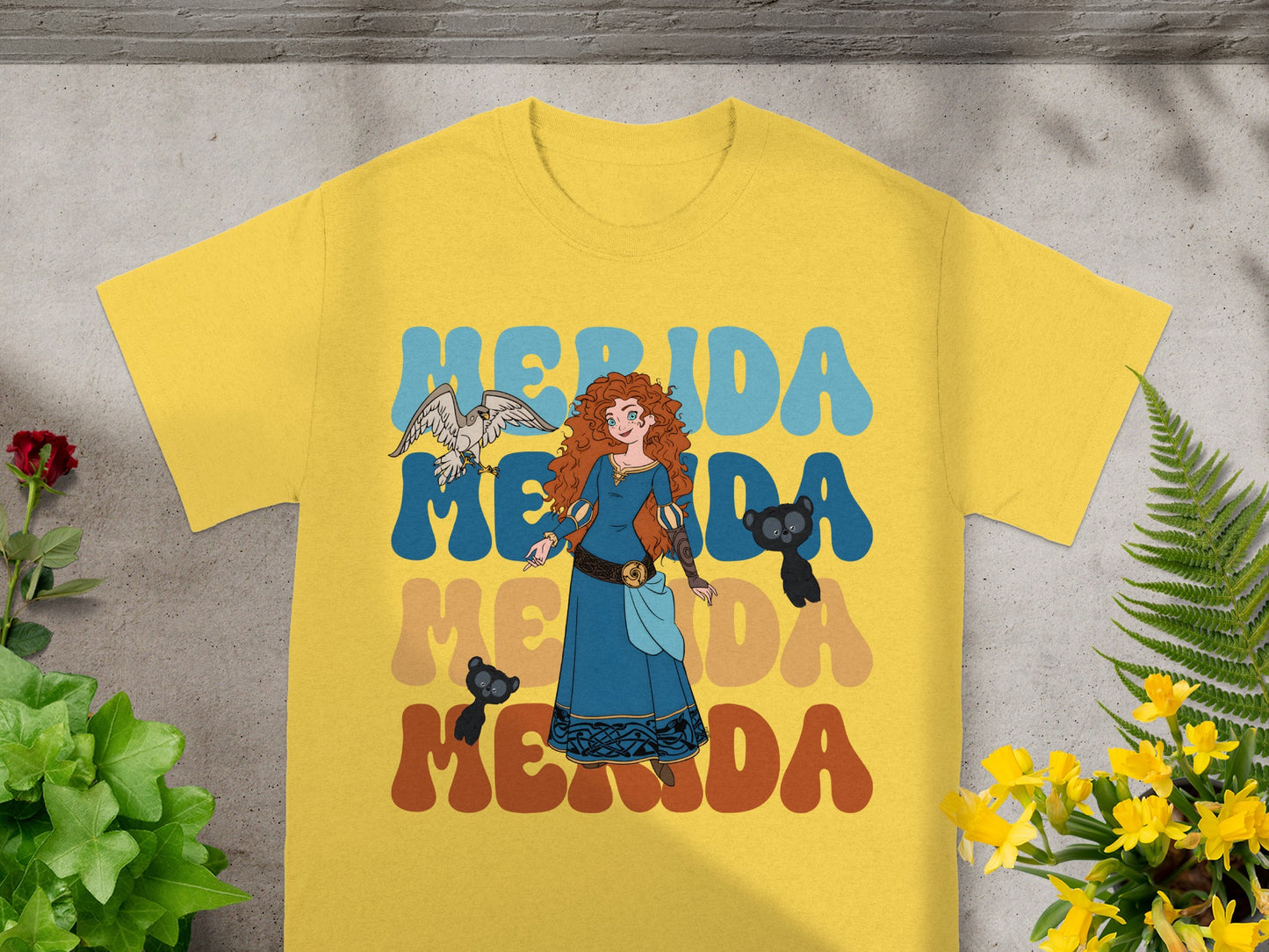 Merida graphic t-shirt with colorful "Merida" text and animated characters.