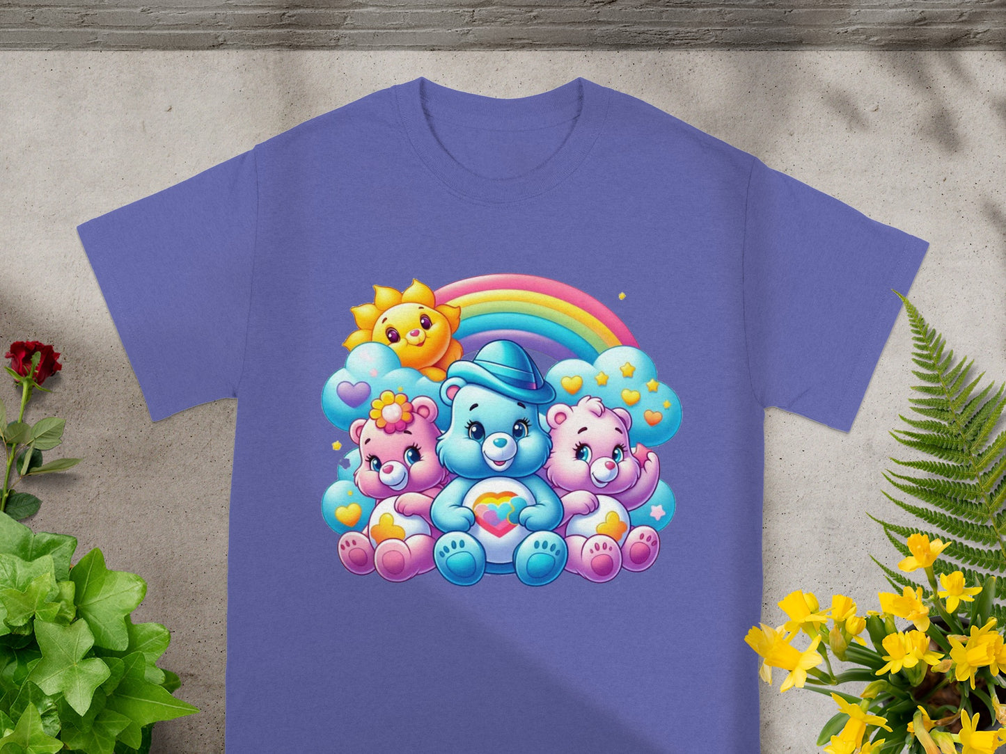 Three Care Bears with rainbow and sun graphic on a purple t-shirt.