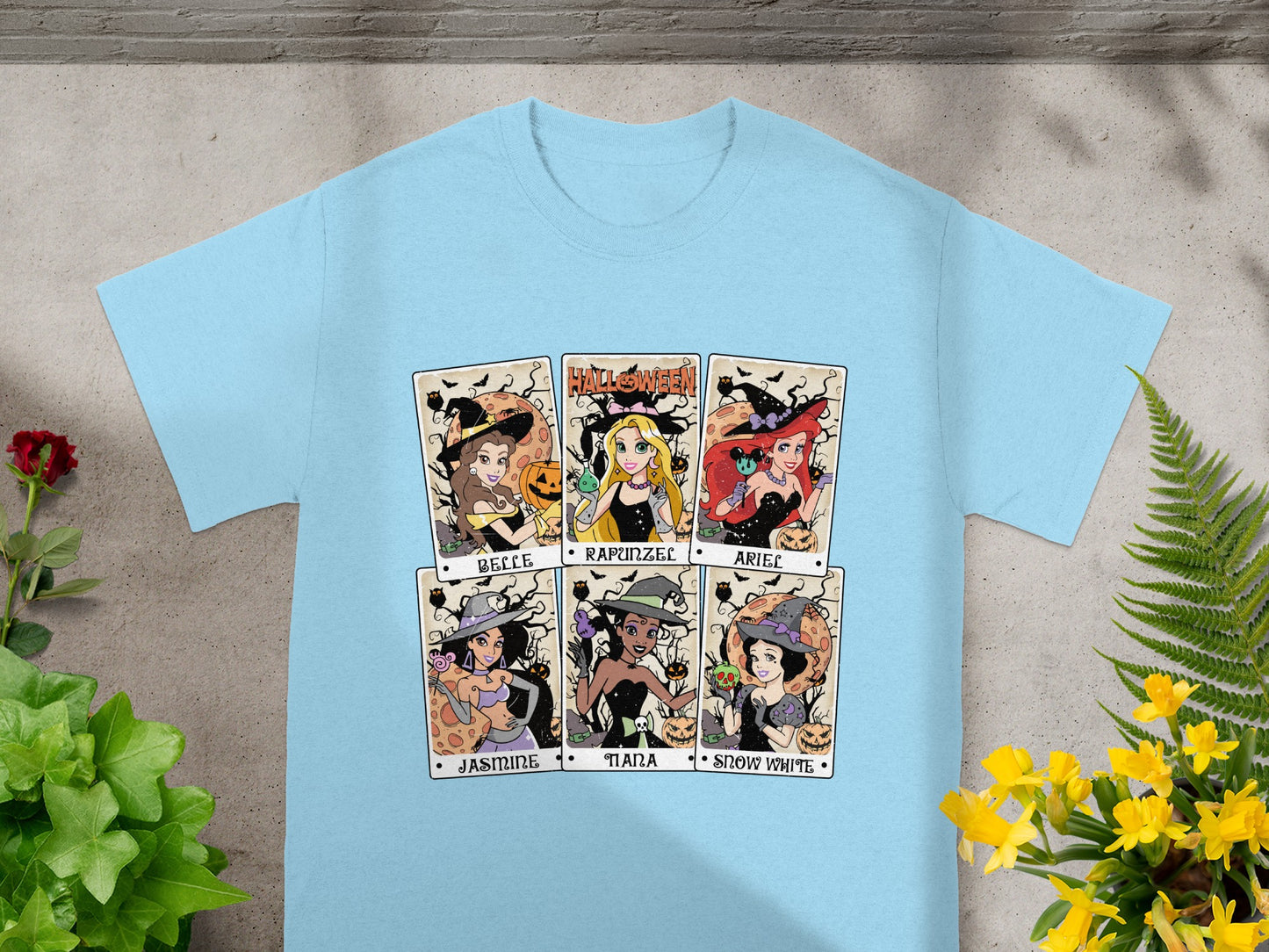 Light blue t-shirt with six Halloween-themed Disney princess cards: Belle, Rapunzel, Ariel, Jasmine, Tiana, Snow White.