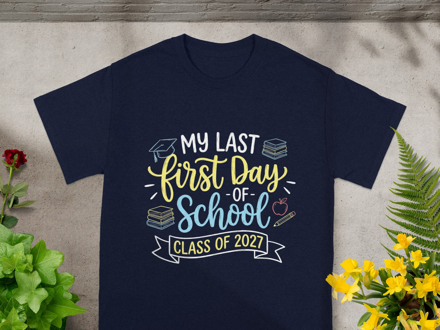 Dark blue t-shirt with "my last first day of school, class of 2027" graphic.