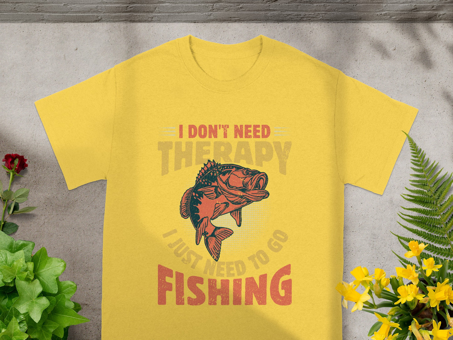 Yellow t-shirt with graphic of a fish and text "I DON'T NEED THERAPY, I JUST NEED TO GO FISHING."