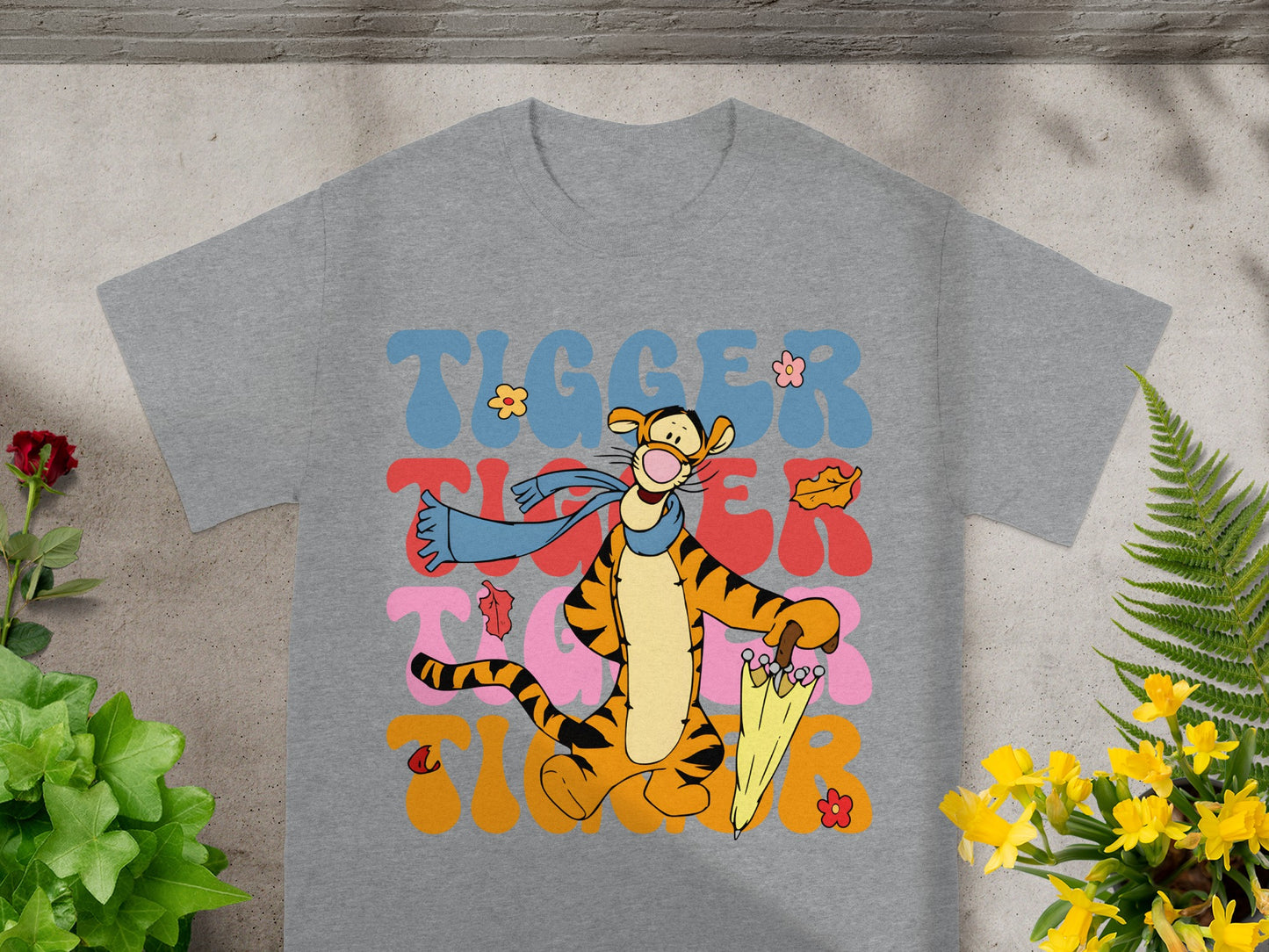Tigger from Winnie the Pooh on a gray t-shirt with colorful text.