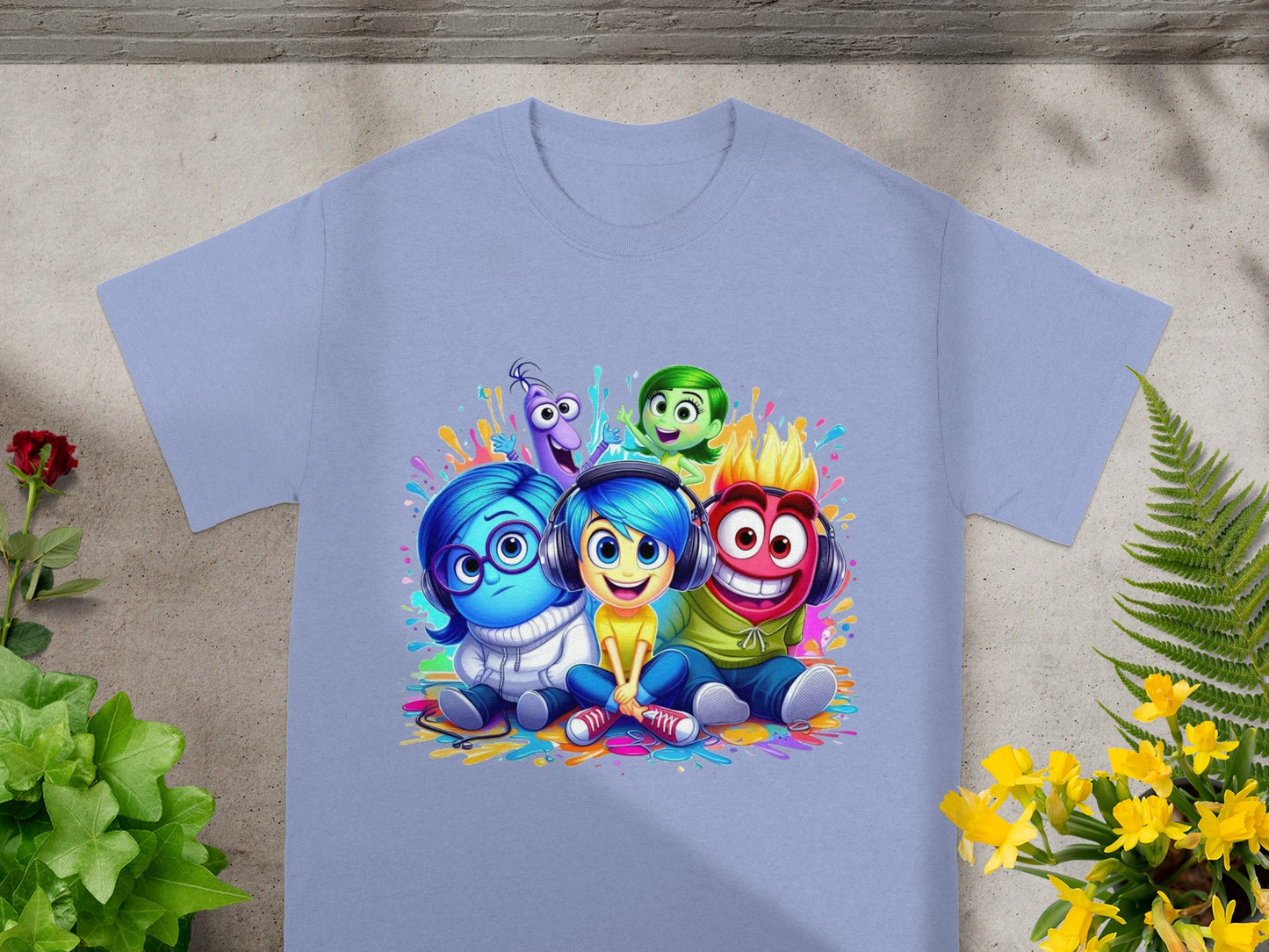 Inside Out characters Sadness, Joy, Fear, Disgust, and Anger on a light blue t-shirt.