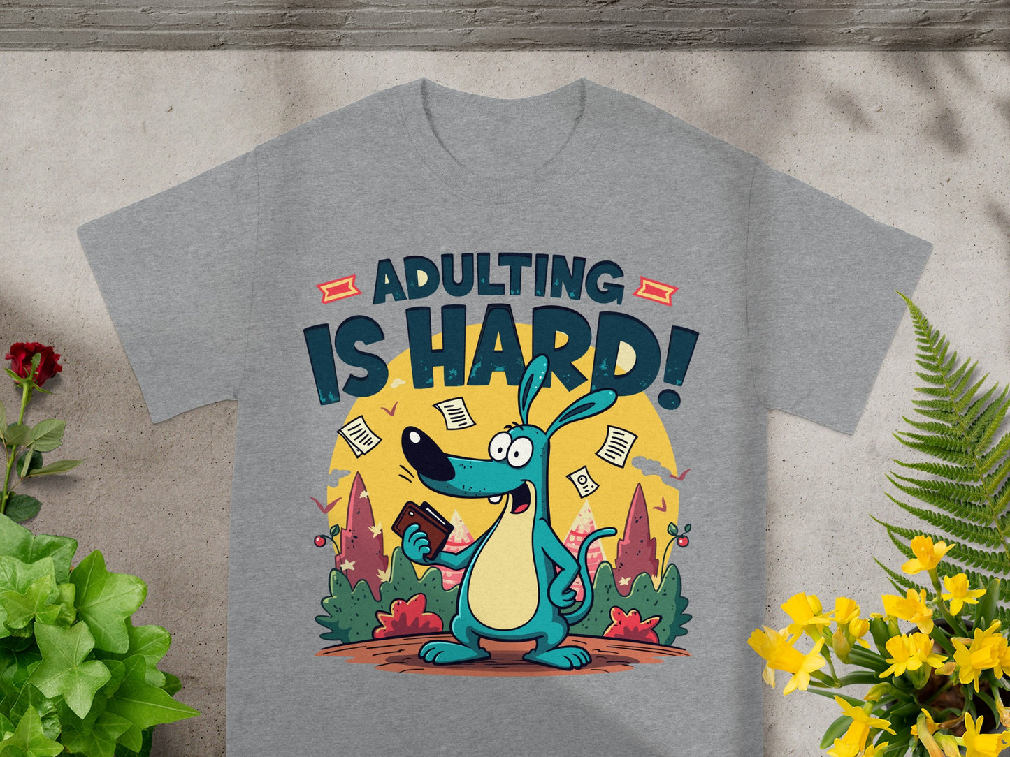 Grey t-shirt with cartoon dog holding wallet and text "ADULTING IS HARD!"