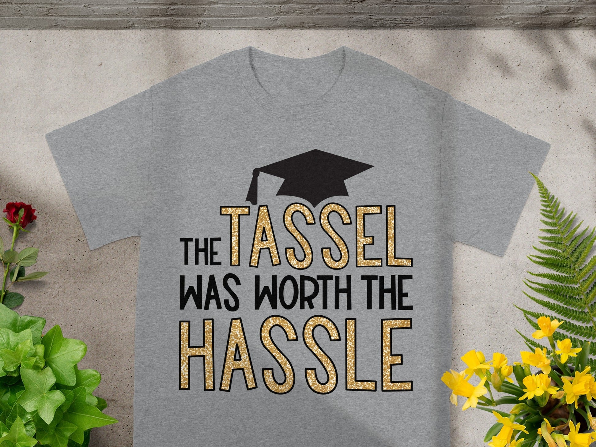 Grey t-shirt with graduation cap and text "The tassel was worth the hassle".