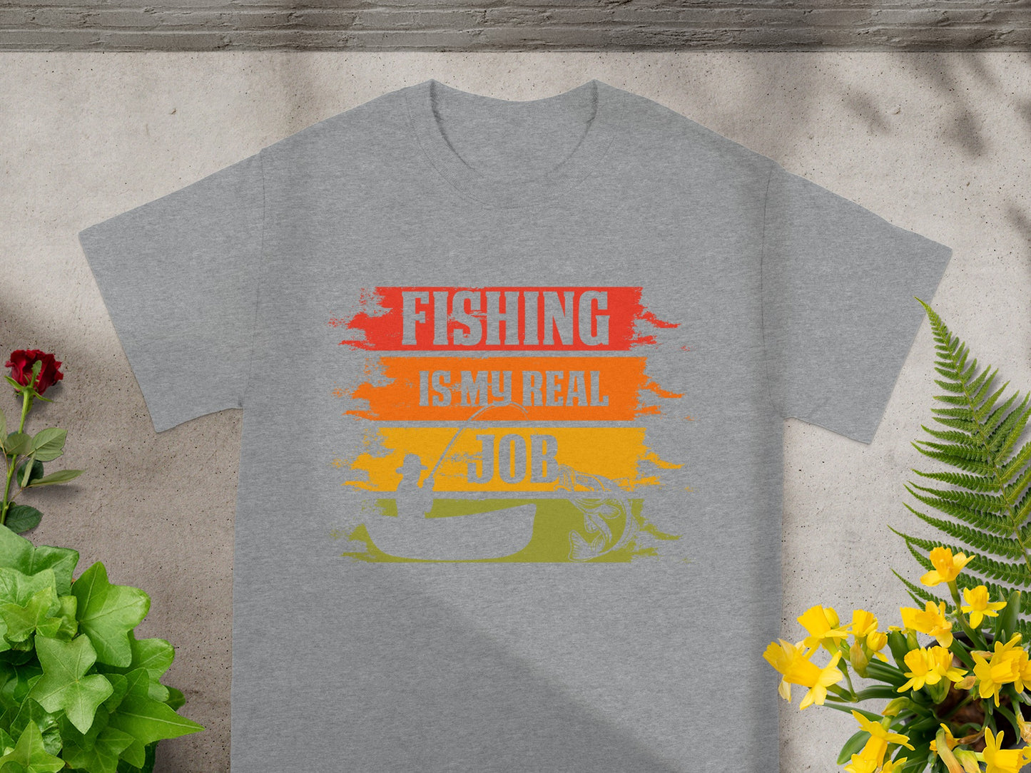Grey t-shirt with "FISHING IS MY REAL JOB" graphic featuring fishing scene.