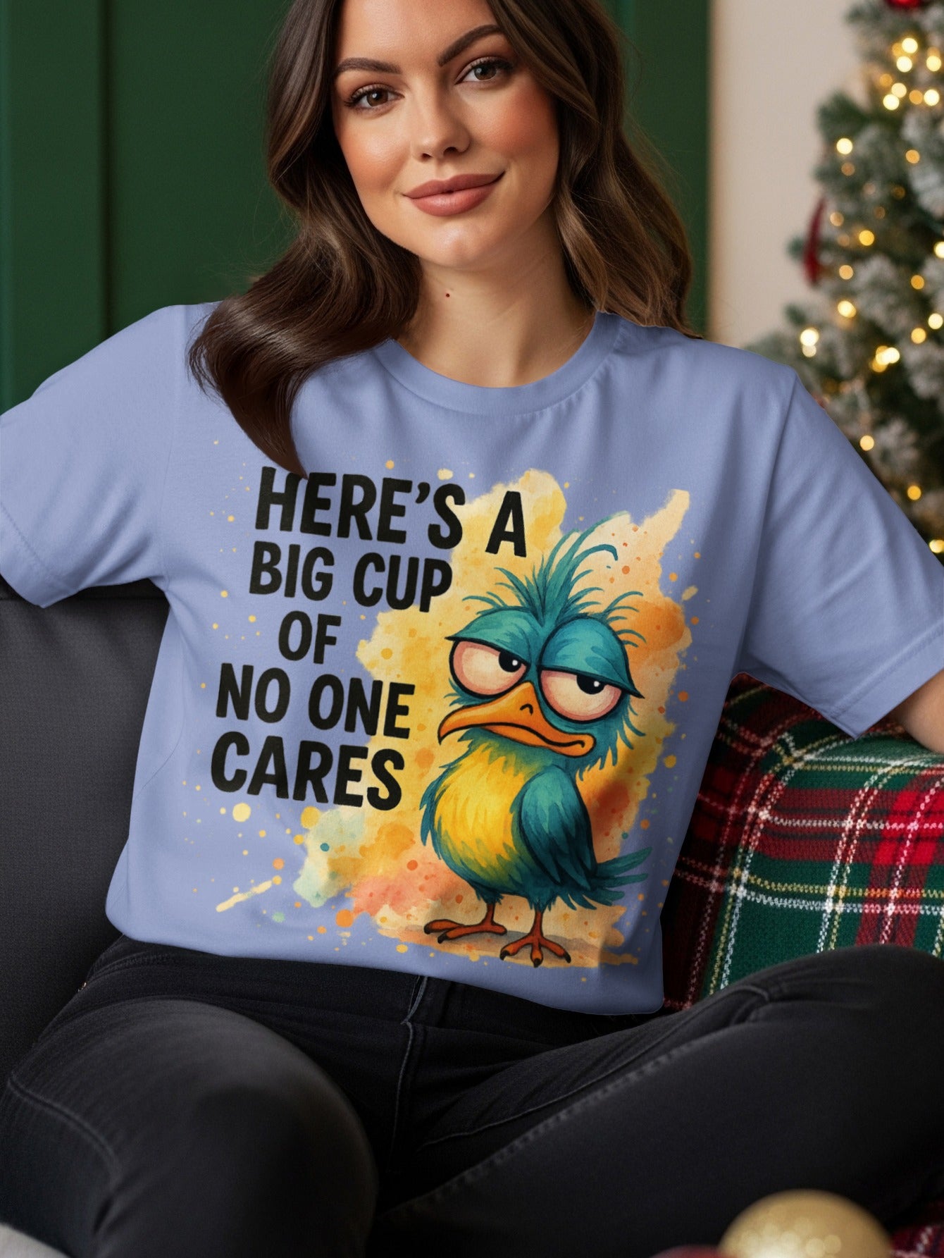Blue t-shirt with a grumpy bird and text "HERE'S A BIG CUP OF NO ONE CARES".